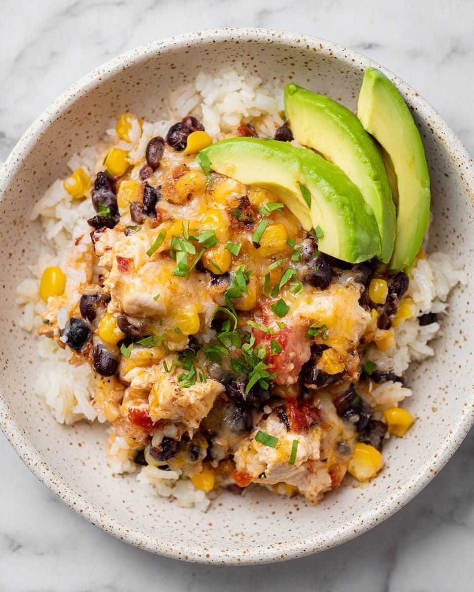 A close-up of a dish served on a white speckled plate placed on a white marbled surface, featuring a base layer of white rice mixed with black beans and corn. On top, there are chunks of cooked chicken covered in melted cheese, more corn, black beans, and small tomato pieces, giving a mix of yellow, black, and red colors with a melted texture. Three bright green slices of avocado are placed on one side, and small bits of chopped green herbs are scattered on top, adding freshness and color contrast. Photo taken with an iphone --ar 4:5 --v 7