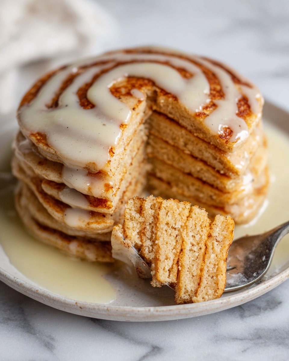 A tall stack of seven golden-brown pancakes with a soft, fluffy texture is placed on a white speckled plate. Each pancake has a slightly crispy edge and a warm, inviting color. Creamy white syrup is slowly dripping down from the top, covering the stack with smooth, shiny lines that add a rich contrast to the warm pancakes. The background is a white marbled texture, enhancing the cozy and fresh feel of the image. photo taken with an iphone --ar 4:5 --v 7