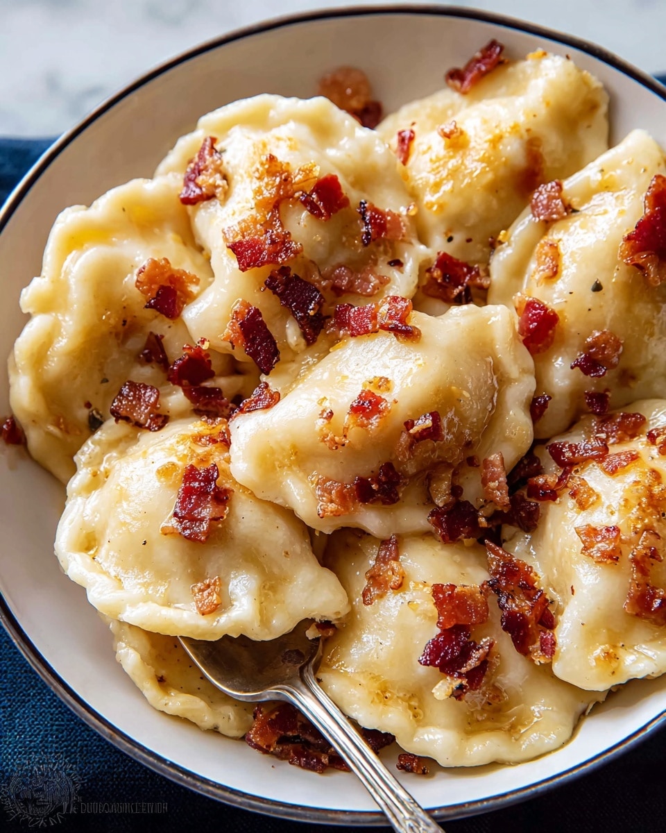 A close-up of a white bowl full of golden brown pierogi, each dumpling having a smooth, slightly shiny texture with some small crisp edges. The pierogi are topped with small pieces of crispy, reddish-brown bacon scattered evenly across the dish. A silver fork rests on the right side of the bowl, slightly buried among the pierogi. The background is a white marbled surface, making the colors of the food stand out clearly. photo taken with an iphone --ar 4:5 --v 7