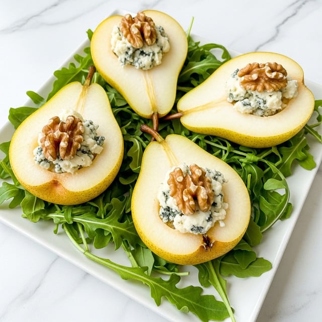 The image shows four halves of yellow-green pears placed on a bed of fresh, dark green arugula leaves arranged on a white square plate. Each pear half is hollowed out at the center, filled with crumbled blue cheese that has a creamy texture with blue veins, and topped with golden-brown walnut halves. The pears have a smooth, slightly shiny skin with some speckles. The arugula leaves add a leafy texture and a deep green contrast to the pears. The plate is set on a white marbled surface, giving a clean and elegant look to the presentation. Photo taken with an iphone --ar 4:5 --v 7