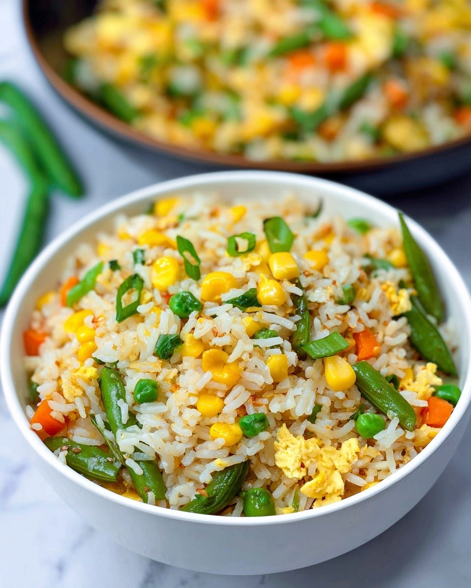 A white bowl filled with three layers of colorful fried rice that looks fluffy and mixed with vegetables. The base layer is white rice with a soft texture sprinkled throughout with bright orange carrot cubes and yellow corn kernels. The middle layer includes vibrant green peas and larger green snap peas that add a fresh look. The top layer is scattered finely chopped green onions that give a pop of green color, making the dish look fresh and tasty. The bowl sits on a dark surface that contrasts with the food, making the colors stand out. photo taken with an iphone --ar 4:5 --v 7